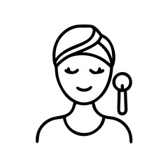 Obraz premium Woman relaxing with skincare tool and a head wrap 