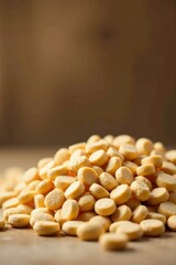 A Close-Up View of a Large Pile of Small, Round, Pale Yellow Baked Goods on a Wooden Surface