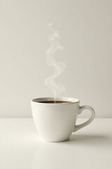 Aromatic steam rises from a freshly brewed cup of coffee, a comforting beverage on a minimalist tabletop