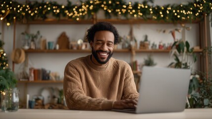 Smiling man using laptop near decorated christmas tree, enjoying festive season and online activities