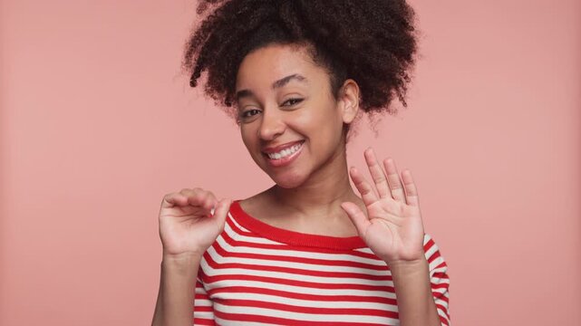 Cheerful woman waving goodbye with a smile
