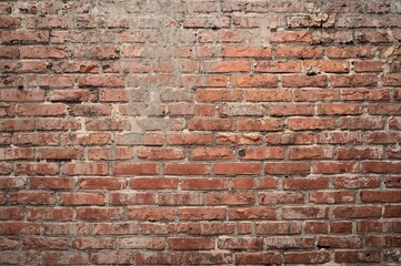 Fototapeta premium Aged and grimy brick wall serving as a backdrop or texture.