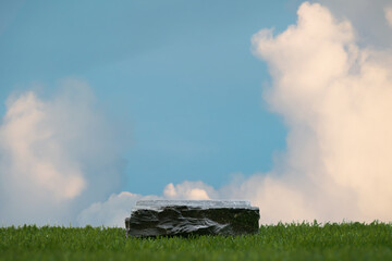 Surreal stone podium with green grass white clouds on blue sky nature forest background.Product present natural placement pedestal minimal display,paradise dreamy concept.