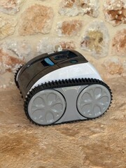 Automatic pool cleaning robot on stone floor