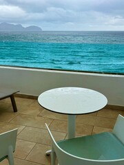 Rainy terrace with sea view and turquoise waves