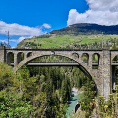 Stone Railway Bridge Over River Gorge in Swiss Alps