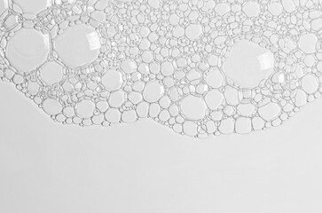 The texture of the foam of shower gel or soap suds or shaving foam. Macrophotography. Copy space