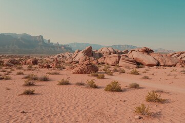 Naklejka premium Desert landscape featuring red rocks under a clear sky