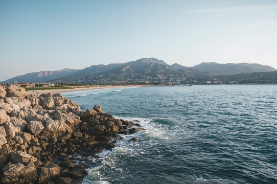 Seaside perspective of a rugged coastline with ample space for text, popular Mediterranean vacation destination