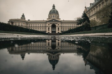 Fototapeta premium Wet pavement reflections captured in a vintage style during a rainy spring afternoon.