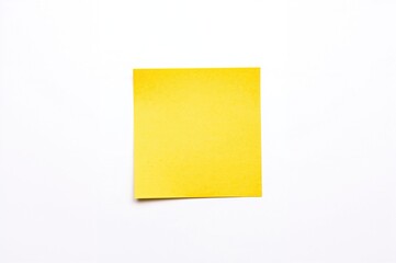 Bright yellow adhesive note against a plain white surface