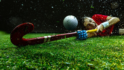 Female hockey player sliding on grass in emotional dive reaching ball. Concept of lifestyle and...