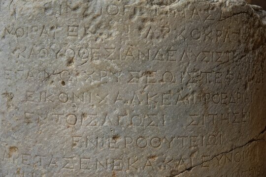 Ancient Greek inscription carved in stone, with clear texture and traces of age, Acropolis, Lindos, Rhodes, island, Greece