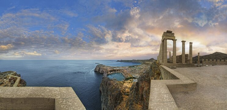Breathtaking view from the Acropolis of Lindos with columns of the Temple of Athena at sunset and dramatic sky, Acropolis, Lindos, Rhodes, Island, Greece