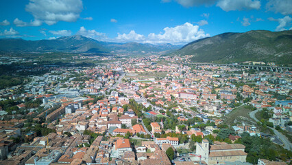 Aerial drone footage of L’Aquila, Italy, showcasing historic architecture, vibrant streets, and...