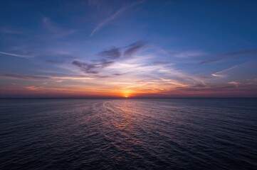 Evening sky over tranquil ocean waters. Sunset scene from a high vantage point.