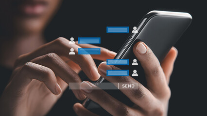 Close-up of hands typing messages on smartphone with chat bubbles concept.