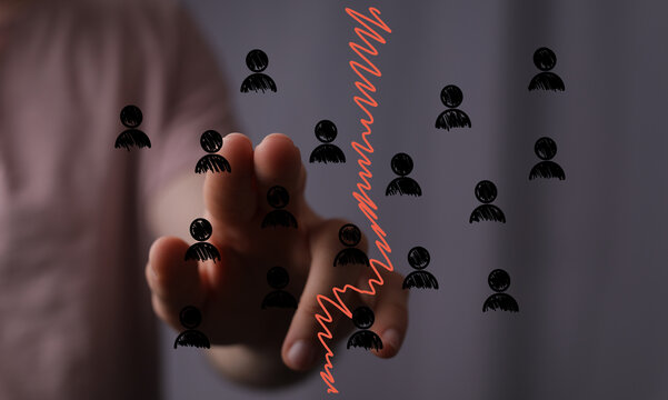 Hand pointing at declining graph, symbolizing job losses, layoffs, downsizing, and workforce reduction.