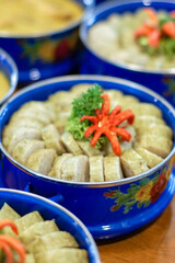 Traditional Indonesian Lontong Rice Cake Served in Blue Enamel Bowl with Chili Garnish