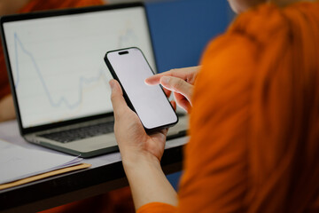 Monks and priests, men in orange robes, use smartphones with white screens.