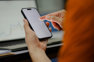 Monks and priests, men in orange robes, use smartphones with white screens.