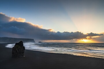 View from Cape Dyrhólaey at sunrise, rock formations Reynisdrangar and the mountain Reynisfjall, Vík í Mýrdal, Suðurland, Iceland