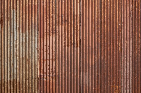 Weathered corrugated metal surface with a rustic galvanized texture