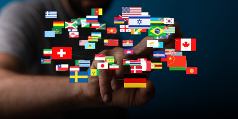 A person's hand interacting with a network of international flags representing worldwide diversity and digital connection. Ideal for global them