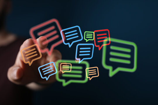 Digital conversation concept shown with finger touching network of vibrant colorful speech bubbles, connecting individuals with shared interests