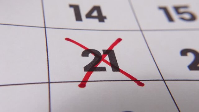 Highlighting date number 21 on a calendar, with a bold red cross mark emphasizing an important reminder or scheduled event.