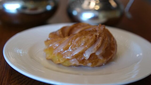 Assorted pastry set with croissants, butter and espresso on a wooden table on a sunny day. High quality 4k footage