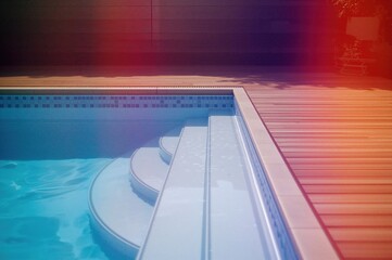 Deck and stairway leading into a swimming pool