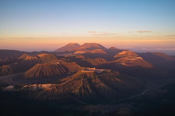 Naklejka premium Sunrise Illuminates Volcanic Peaks in a Remote Region