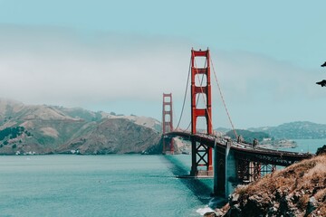 Golden Gate Bridge on a Sunny Day, San Francisco. The Golden Gate Bridge stretches across San Francisco Bay under a bright blue sky.