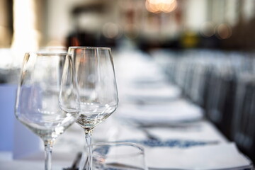 Empty wine glasses on a set, formal dinner table. Close up shot, shallow depth of field, no people