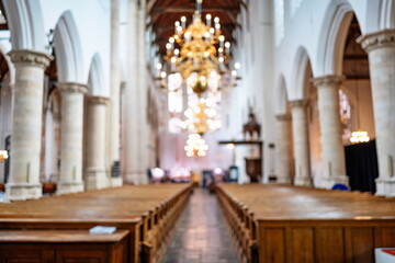 Fototapeta premium Blurry or defocused medieval European church interior. Wide angle view, abstract background, no people, selective focus