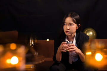 Closeup business woman holding a glass of whiskey