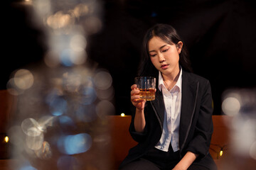 Closeup business woman holding a glass of whiskey