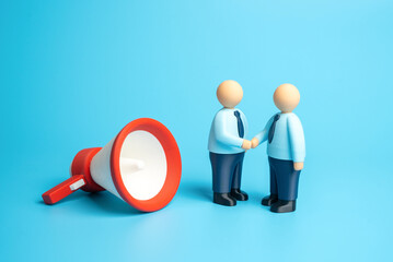 Office workers confer around a red megaphone. Concept for a marketing campaign and advertising services contract. Communication strategies, business promotion. Collaboration in corporate branding.
