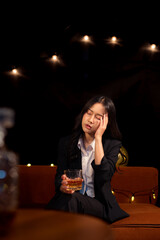 Closeup business woman holding a glass of whiskey
