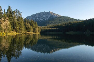 Fototapeta premium Scenic view of the higher Fusine Lake framed by Mount Mangart in the distance.