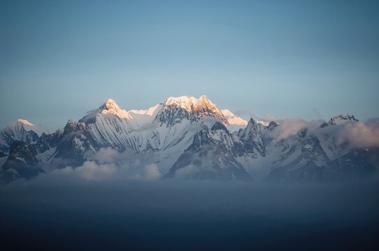 A tranquil snowy peak under a clear blue sky radiates serenity and peace - Powered by Adobe