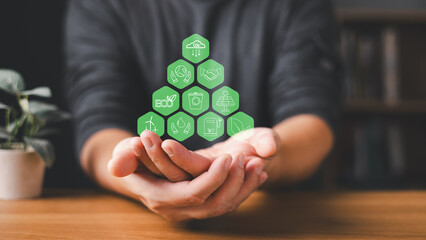 person hold glow green hexagonal icon representing sustainability, renewable energy, and eco-friendly innovation in open hand.Symbol highlight recycling, solar power, and environmental responsibility.