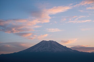 Fototapeta premium Outline of a peak against a backdrop of clouds and rays of light