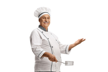 Mature male chef holding a turner