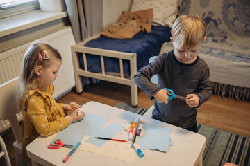 Children doing creative crafts at home