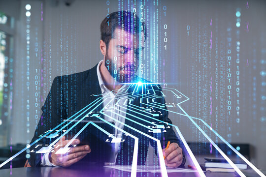Businessman using tablet and writing with stylized digital circuit and binary code overlay representing futuristic data technology concept.