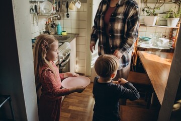 Children helping adult preparing family dinner