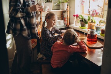 Mother and children enjoying family time in kitchen