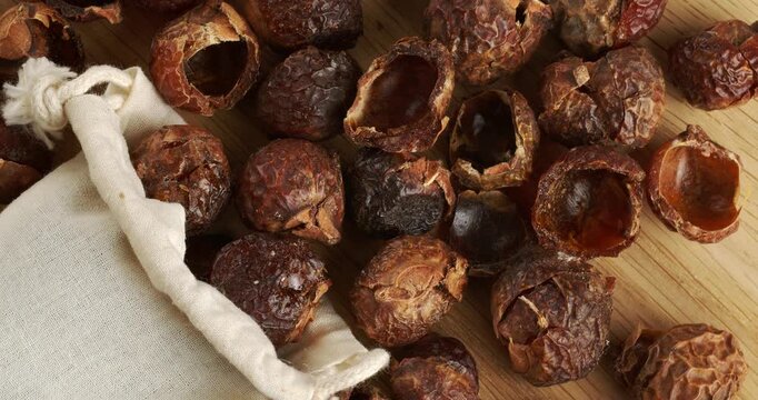 Soap nuts and eco laundry bag, close-up footage on a rotating table.